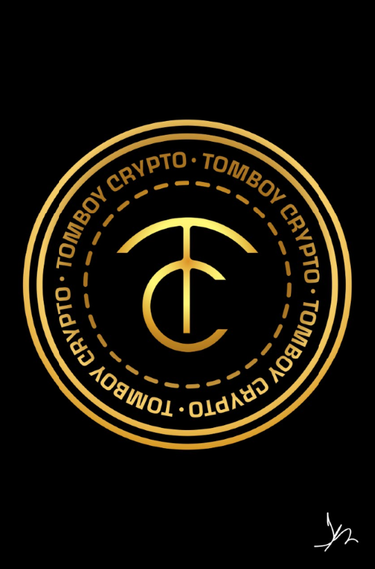 A gold colored logo of tomboy crypto.